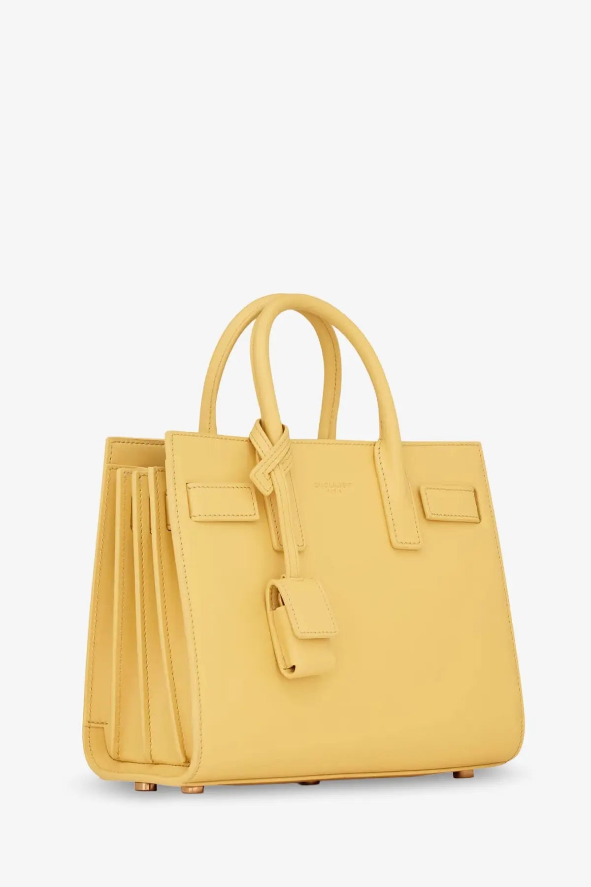Saint Laurent women’s sac de jour nano leather crossbody bag in pale yellow with structured handles and front flap closure