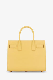 Saint Laurent women’s sac de jour nano leather crossbody bag in mustard yellow with a sleek minimalist design