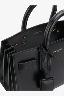 Saint Laurent women’s sac de jour nano black leather crossbody handbag with gold-tone hardware and logo embossing