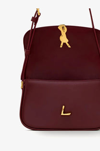 Saint Laurent women’s Solferino mini leather shoulder bag in burgundy with gold bird-shaped clasp and L logo emblem
