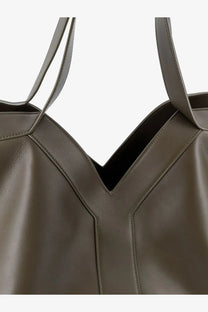 Saint Laurent women’s olive green leather tote bag with structured y-shaped stitching and minimalist design