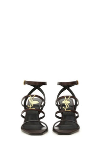 Saint Laurent women’s wedge cassandras black leather strappy sandals with gold tone YSL logo embellishments