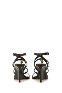 Saint Laurent women’s wedge cassandras black patent leather strappy high heels with gold-tone ysl logo on the heel back view