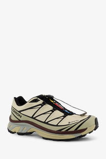 Beige and black salomon xa pro 5 gtx trail running shoe with rugged waterproof design for men in green technical fabric