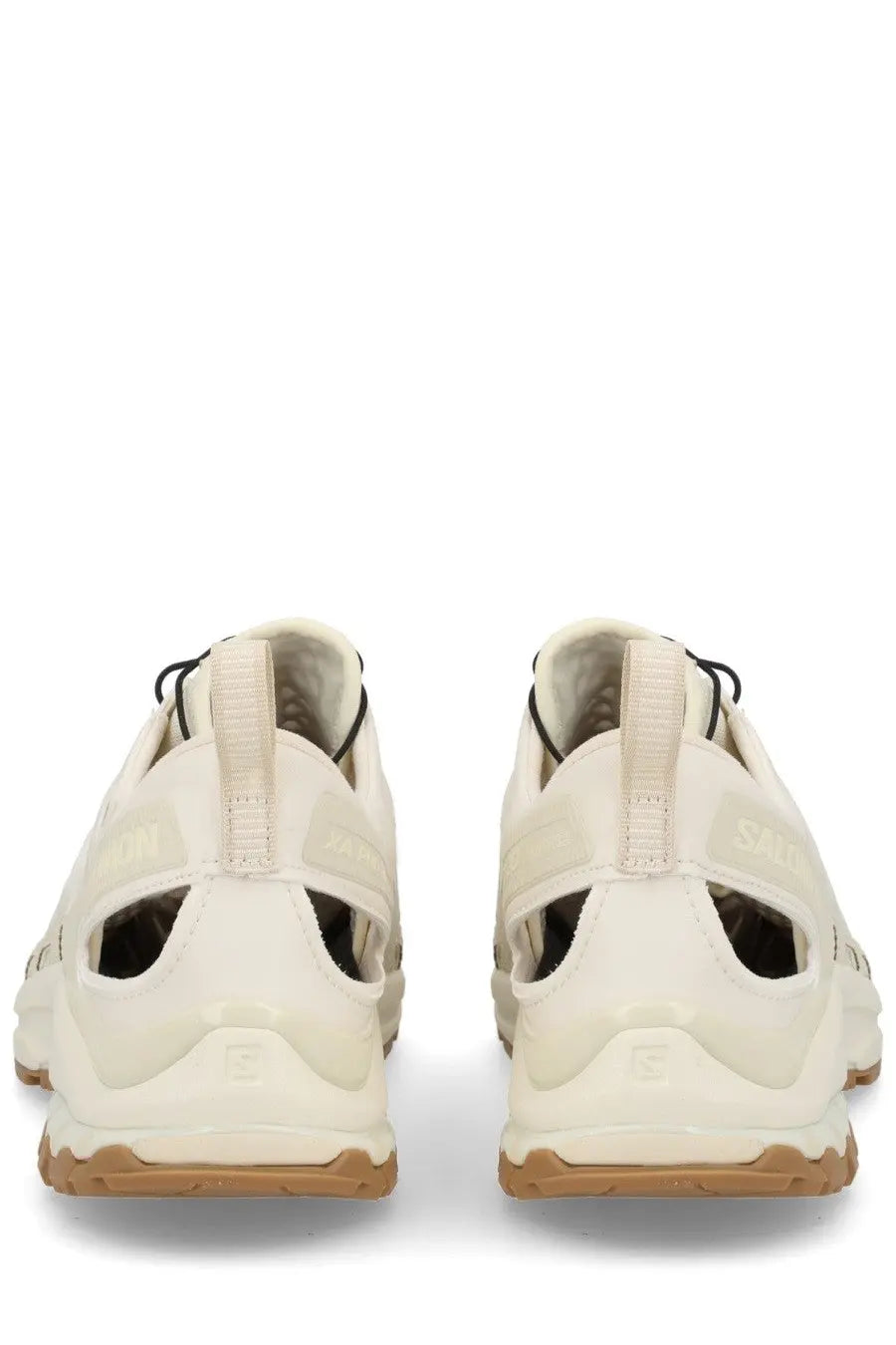 Cream-colored salomon unisex xa pro 3d amphib sneaker with black laces and textured rubber outsole for trail running