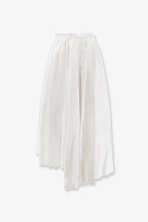 A white pleated cotton skirt by self-portrait featuring an elastic waistband and a slightly asymmetrical hemline