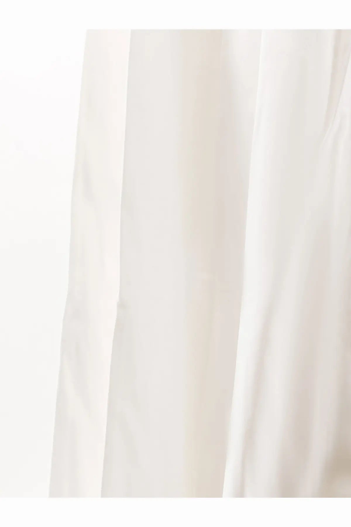 A soft flowing white cotton curtain with gentle vertical folds showcasing lightweight fabric texture