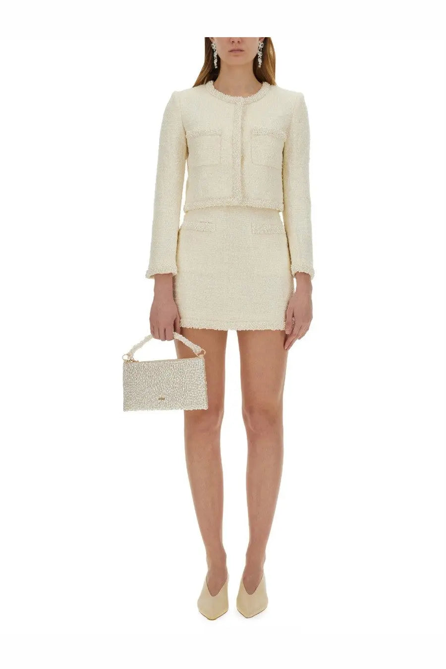 Cream-colored boucle mini skirt and matching cropped jacket with small sparkling beaded handbag by self-portrait women