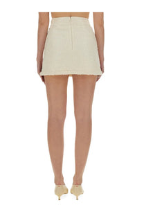 Cream-colored self-portrait women’s boucle mini skirt with frayed hem and back zipper shown from back side