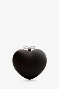 Black heart-shaped crystal clutch bag with silver bow closure and sparkling embellishments by Self-Portrait