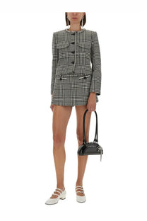Black glossy mini handbag with silver chain strap and decorative clasp paired with self-portrait multicolor houndstooth jacket