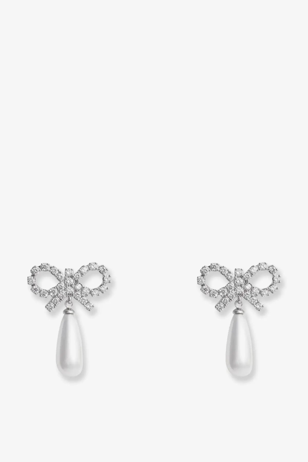 Delicate self portrait women’s silver brass earrings with silver bow, sparkling crystals, and dangling white teardrop pearls