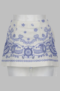 Self portrait women’s white lino skort featuring a mini skirt design with blue embroidered paisley and floral hem patterns