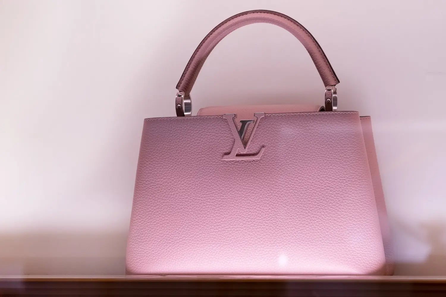 Soft pink textured leather LV handbag with silver logo hardware