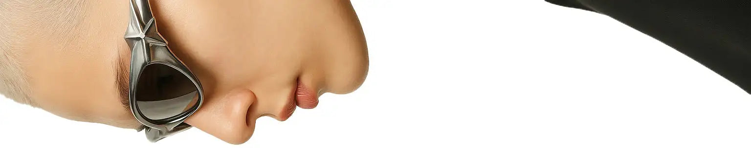 Silver-framed swim goggles with dark lenses, worn over a person’s face.