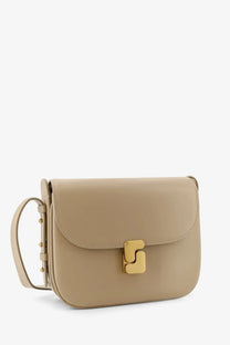 Beige leather crossbody bag with gold-tone s-shaped clasp and adjustable strap from Soeur women’s Bellissima mini collection