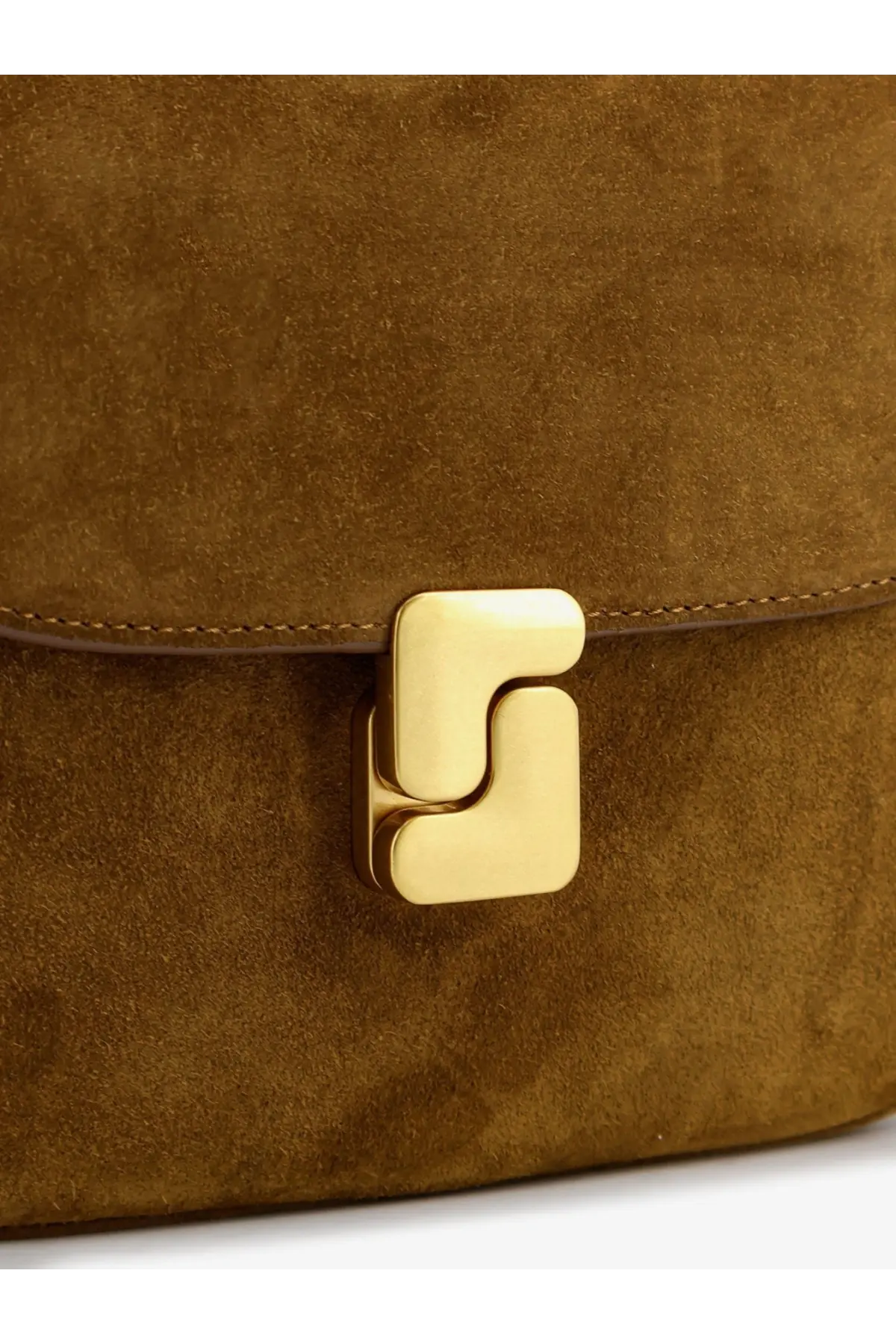 A golden geometric clasp on the textured brown suede of the Soeur women’s Bellissima mini beige crossbody bag
