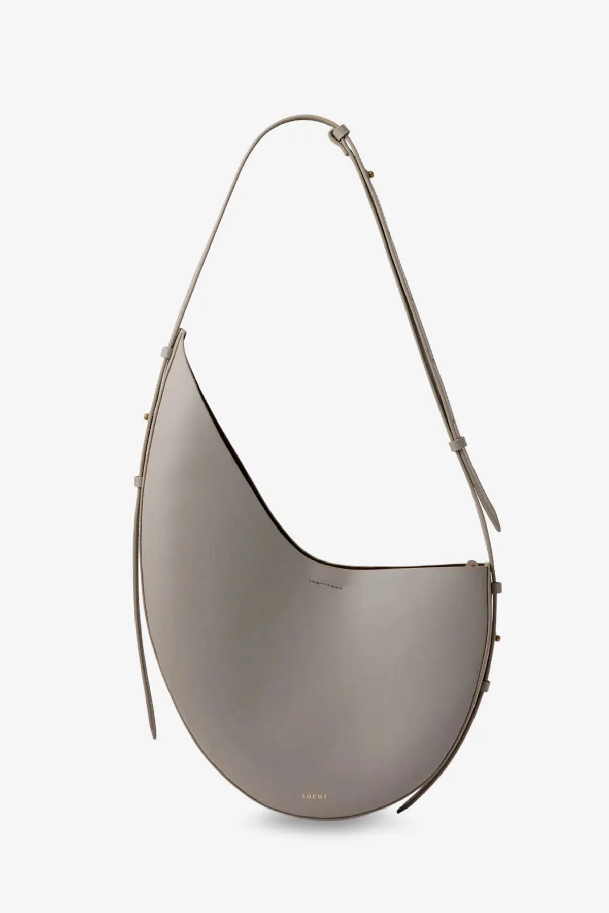 Soeur women’s Winona leather crossbody bag in gray with a sleek minimalist curved silhouette and adjustable strap