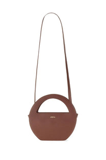Brown leather mini edda bag with round top handle and slender shoulder strap for women by sofia