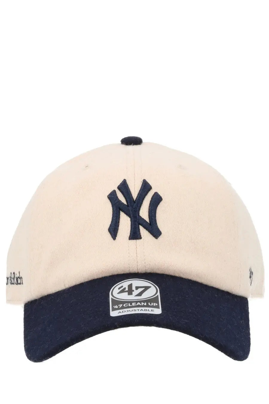Cream-colored sporty &amp; rich unisex baseball hat with navy ny logo embroidered and navy brim featuring adjustable label