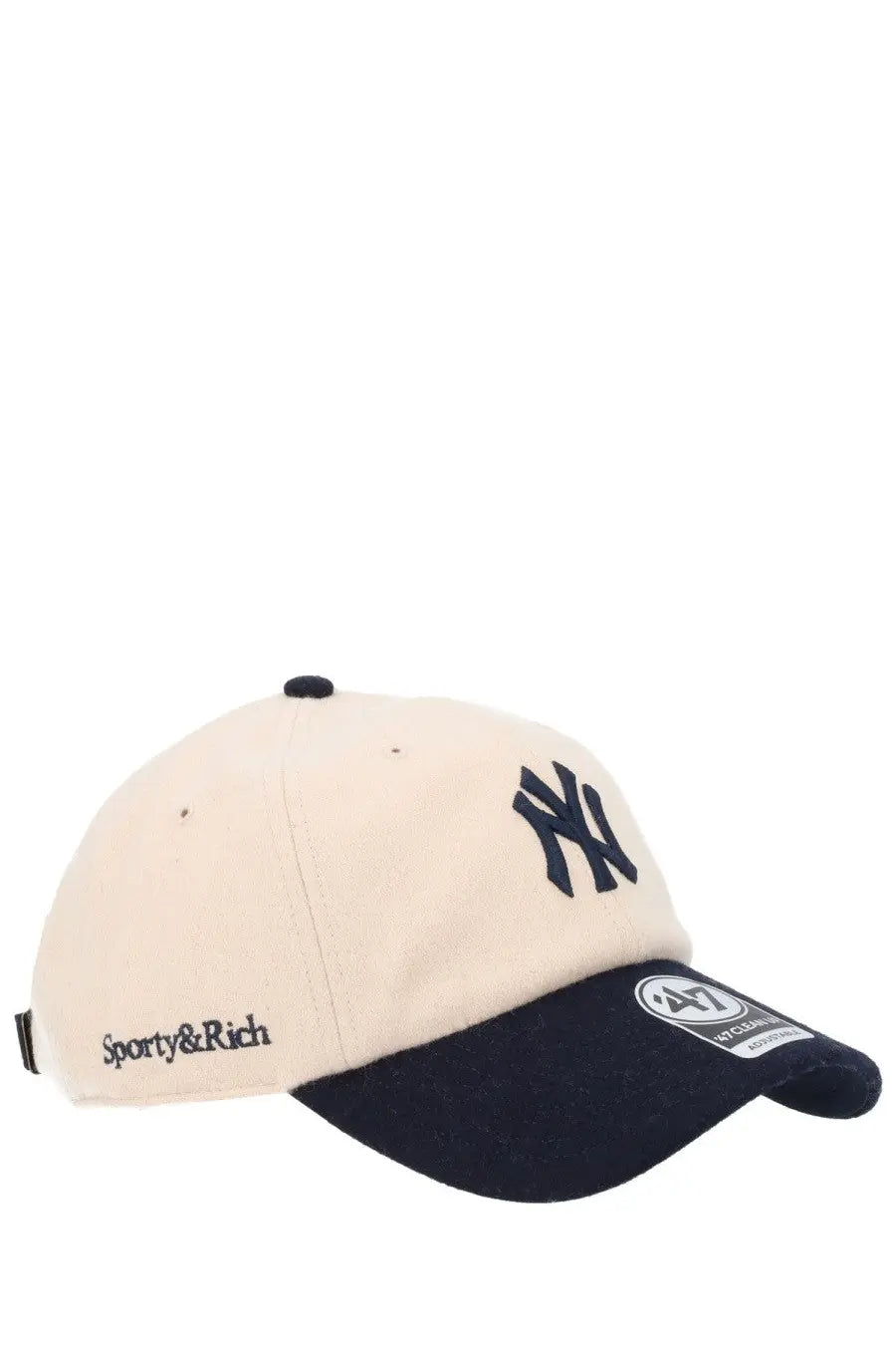 Sporty &amp; rich unisex beige baseball hat with cream color, navy blue brim, ny logo, black button, and side brand stitch