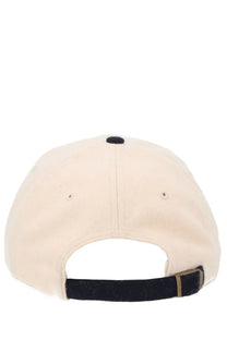 Cream-colored cotton sporty and rich unisex baseball hat showing back with black adjustable strap and button
