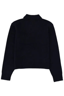 Black cropped turtleneck sweater with ribbed cuffs and hem paired with sporty and rich unisex blue cashmere polo shirt