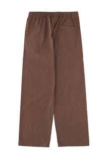 Brown sporty &amp; rich unisex loose-fitting pants with elastic waistband and single back pocket shown from the back side