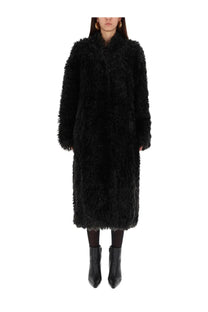 Stand Studio women’s coat Carolina black is a black long fluffy faux fur coat with high collar and full-length sleeves