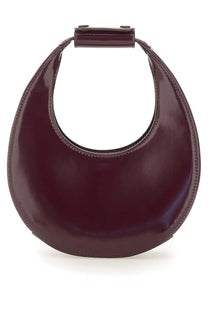 A sleek burgundy leather staud women’s mini moon bag with a minimalist crescent shape and top handle