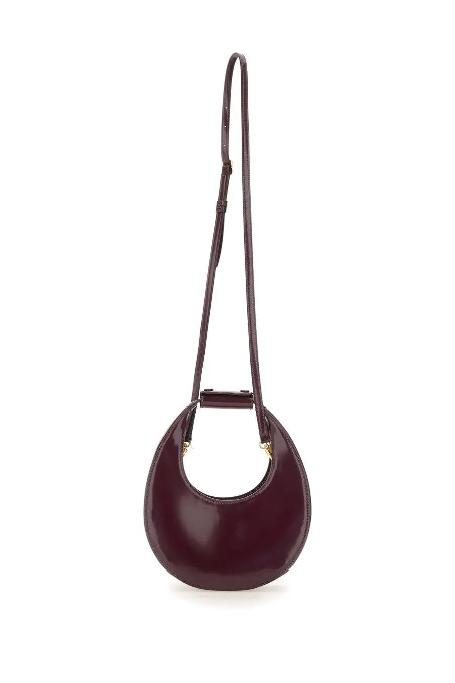Staud women’s mini moon bag in glossy burgundy leather with minimalist circular design and adjustable slender strap