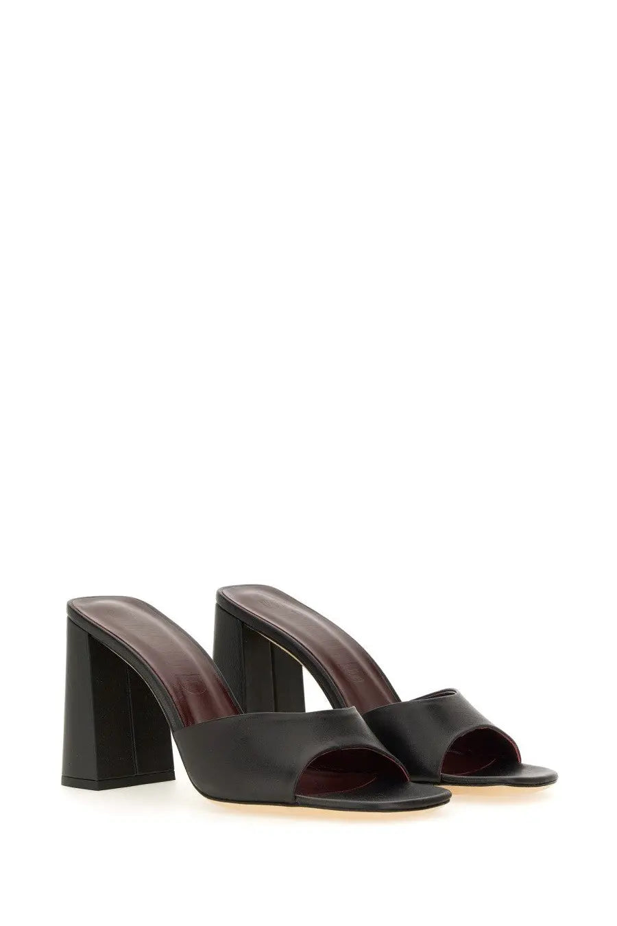 Black leather mule sandals by Staud for women with chunky block heel and open toe design in black