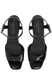 Stella McCartney women’s Elyse black sandal wedges in patent leather with minimalist design and gold-tone buckle accents