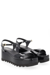 Stella McCartney women’s black patent leather platform sandals with chunky serrated sole and gold buckle accents