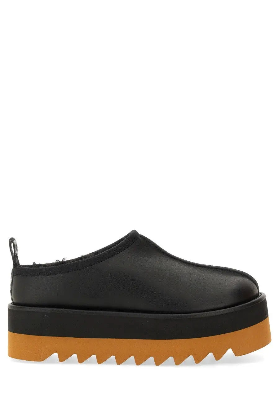 Stella McCartney women’s sneak Elyse black leather slip-on platform shoe with bold orange serrated sole