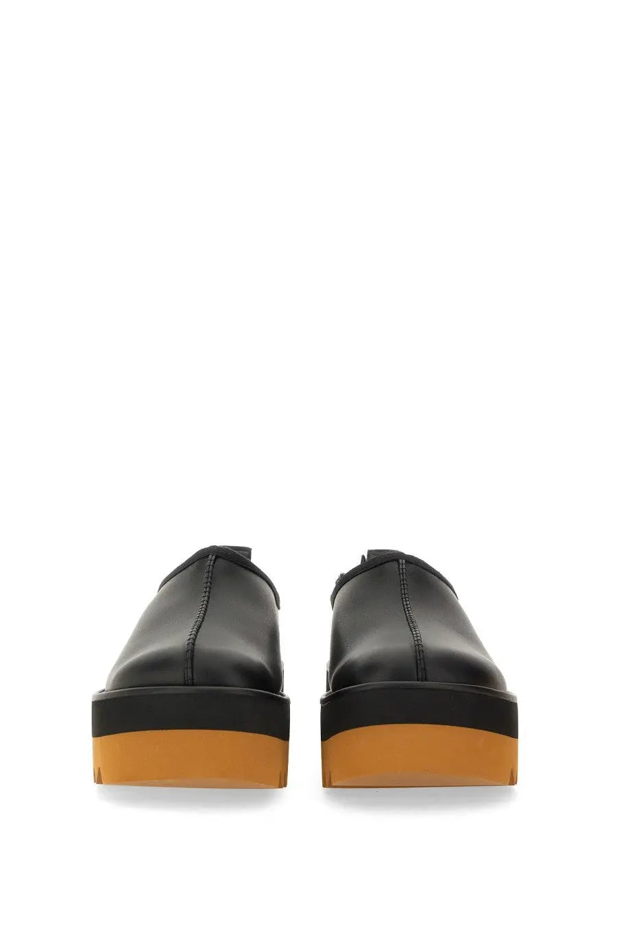 Stella McCartney women’s black leather slip-on platform shoes with bold orange rubber sole front view