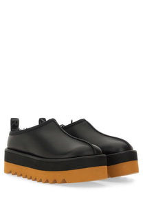 Stella McCartney women’s sneak Elyse black platform loafers with glossy finish and orange rubber soles