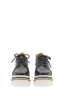 Stella McCartney women’s black leather platform sneakers with white black striped soles and branded laces