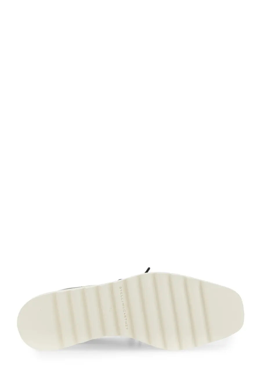 White rubber sole with textured ribbed pattern and subtle branding on the side of stella mccartney womens stringata con zeppa elyse black