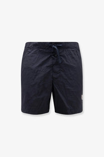 Stone Island men’s econylon swim trunks in dark navy blue with elastic waistband and white logo on lower right leg