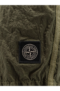 Olive green textured fabric patch with black embroidered stone island compass logo on mens econylon swim trunks