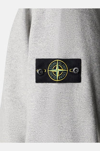 Stone Island men’s élange cotton sweatshirt grey with gray textured fabric and black patch featuring yellow green compass logo
