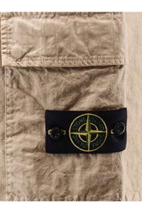 Beige Stone Island men’s nylon shorts featuring a black patch with embroidered green and yellow compass logo