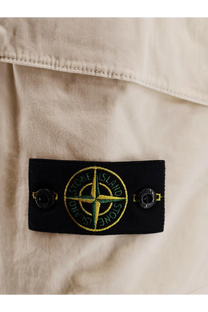 Black rectangular label with yellow and green stone island compass rose logo on Stone Island organic cotton white bermuda shorts