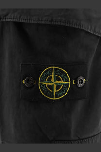 Stone island men’s organic cotton black shorts featuring a black stone island jacket patch with yellow and green compass rose embroidery