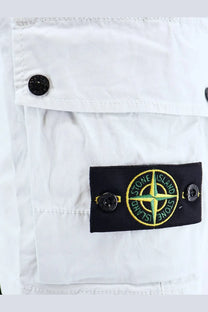 Stone Island men’s organic cotton blue shorts with a black patch featuring an embroidered green compass rose and yellow stitching