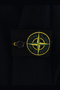 Stone island men’s organic cotton blue sweater with black stone island patch and yellow green compass rose logo