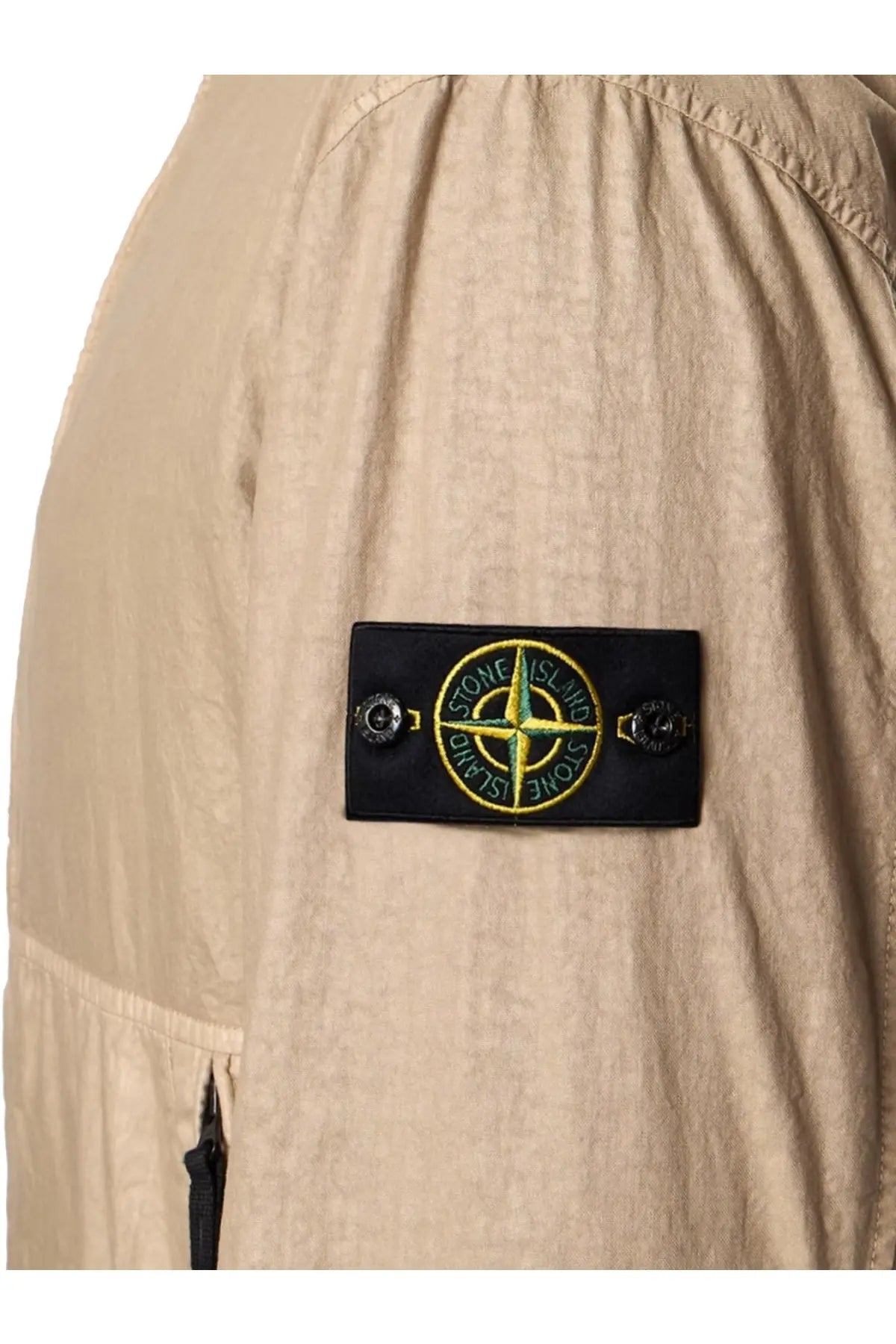 Beige stone island jacket sleeve patch with yellow compass rose and green stone island text on desert nylon panama tc jacket