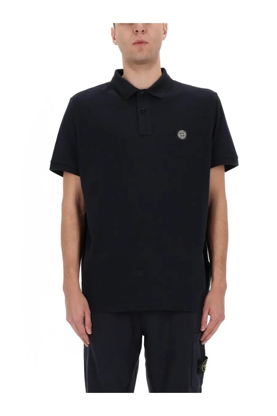 Stone island men’s polo shirt in black with short sleeves textured fabric and small circular logo on left chest
