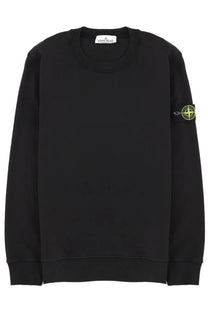 Stone Island men’s black crewneck sweatshirt with neon green compass logo patch on left sleeve and brand tag at neckline